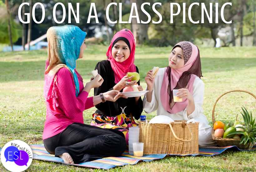 Three adult ESL students enjoy a picnic together as a springtime activity